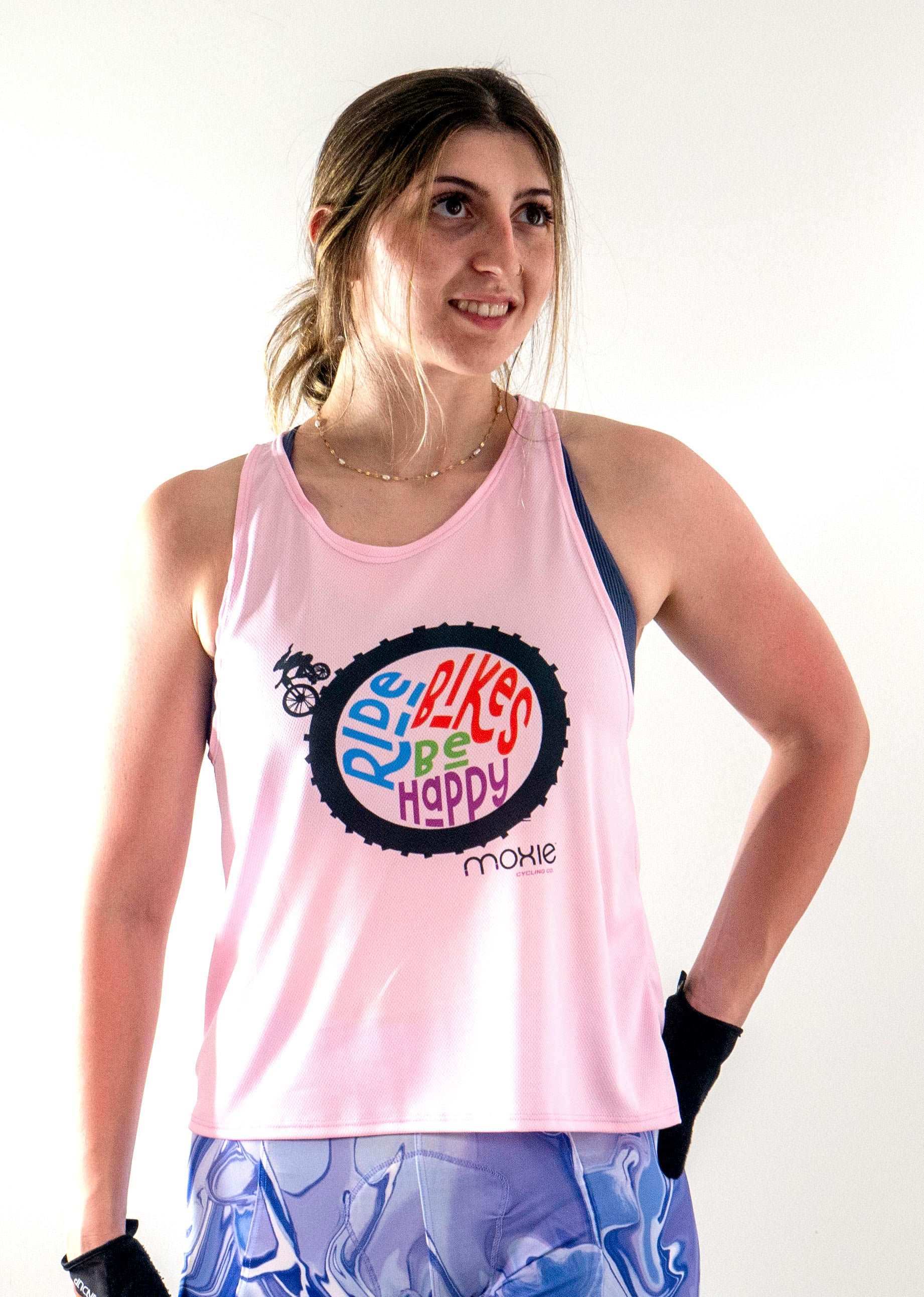 Light pink tank top featuring "Ride Bikes Be Happy" graphic, designed for breathability and comfort, ideal for mountain biking.